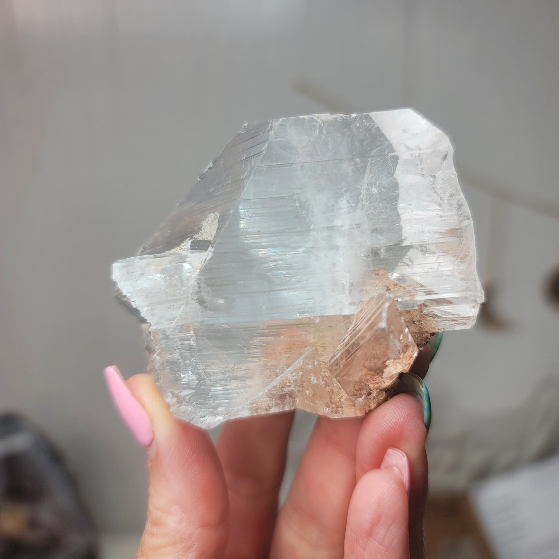 Person holding a Selenite clear crystal or mineral specimen